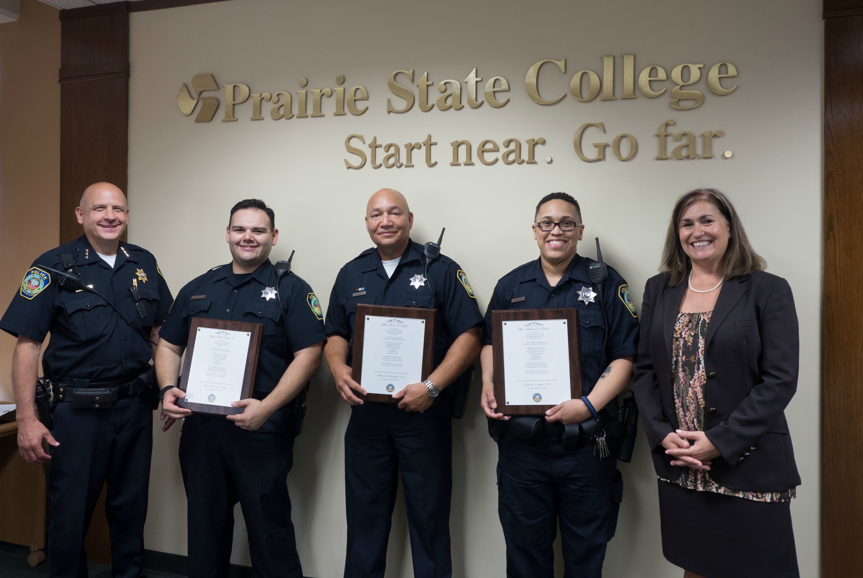 Prairie State College (PSC) Police Chief John P. Murphy, Sr. (left), and President Dr. Terri L. Winfree (right) congratulate newly sworn in officers to the PSC Police Department (from second from left) Gilbert Vargas, Jr., Brian C. Smith, and Brittney D. Jackson. 