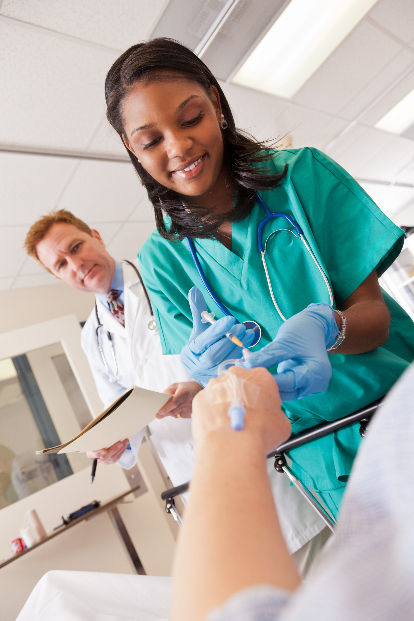 nurse giving patient medicine in IV