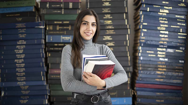 student holding book