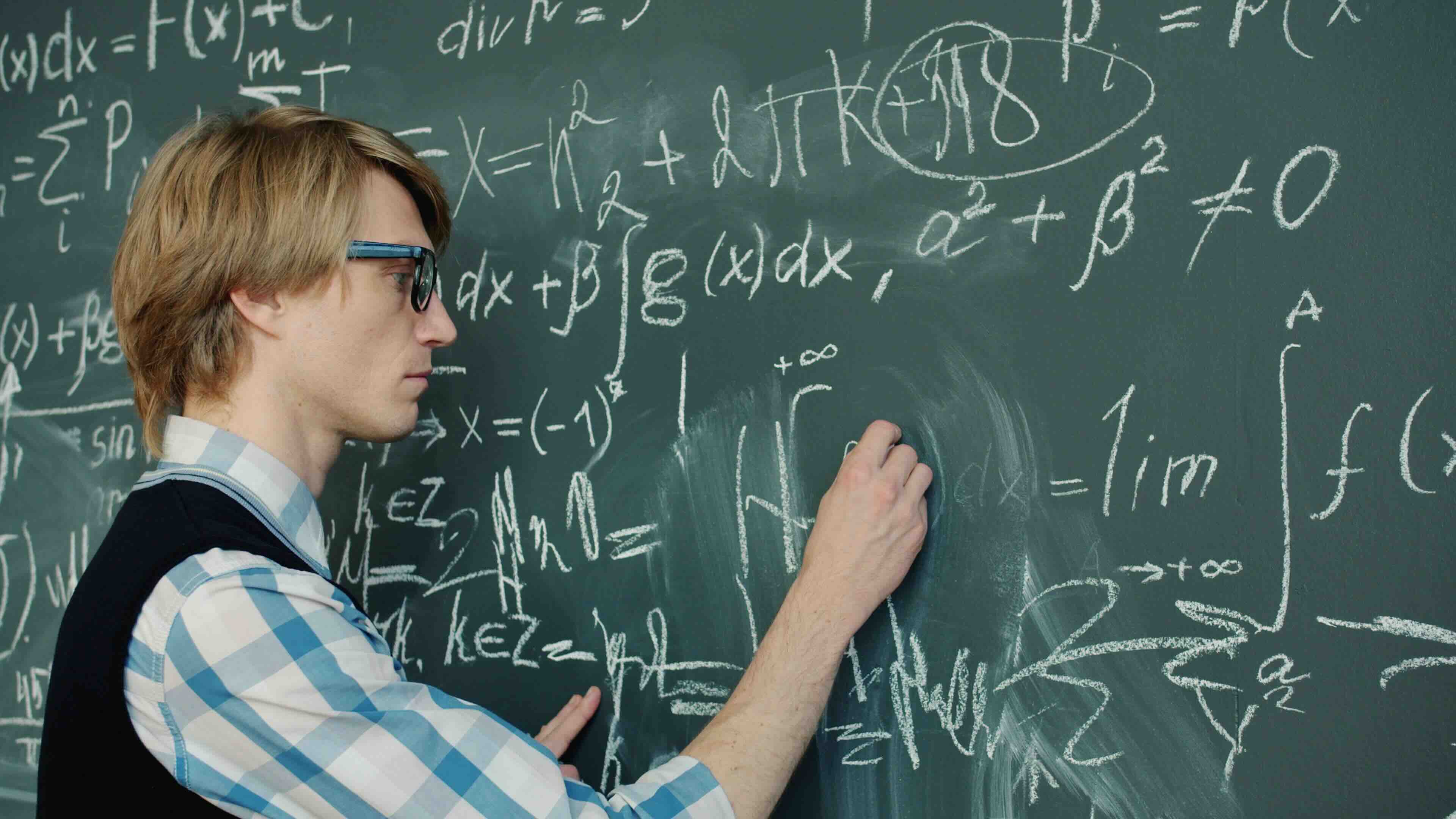 students in classroom standing in front of chalkboard
