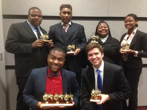 PSC Speech Team Members pose with trophies.