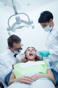 Dentist, patient and dental assistant
