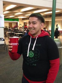 Student with red solo cup and sustainability club t-shirt
